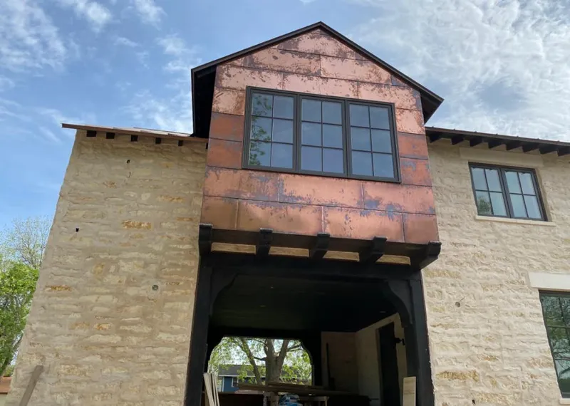 Copper metal panel facade on a stone building for Skylight Installation in Huntersville